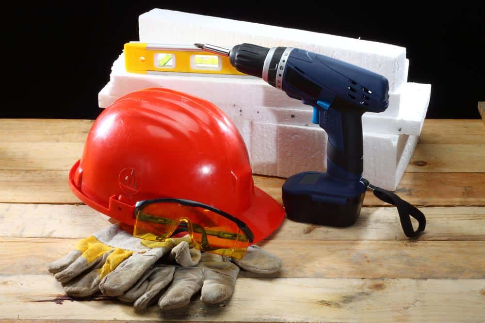 Gloves, googles drill laying on table